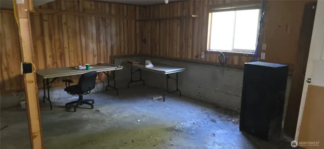 a view of a workspace with furniture and a window