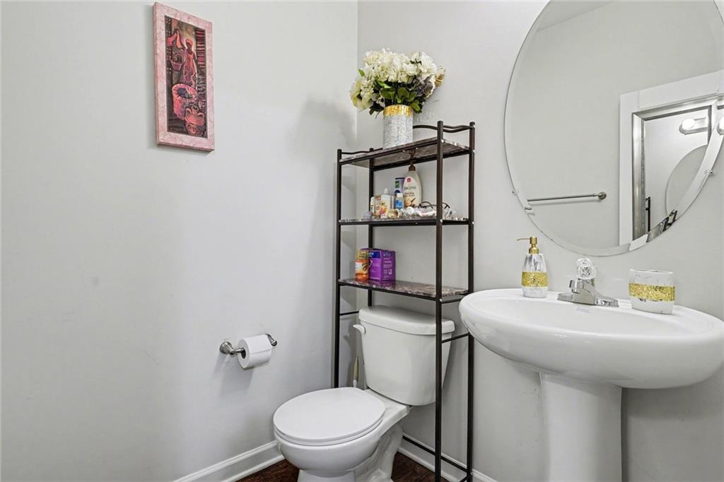 1241 England Terrace Hampton, GA 30228 - Photo 3 of 20 a bathroom with a toilet sink and mirror