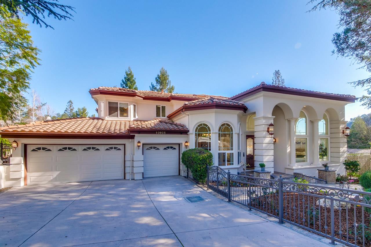 a front view of house with a garden