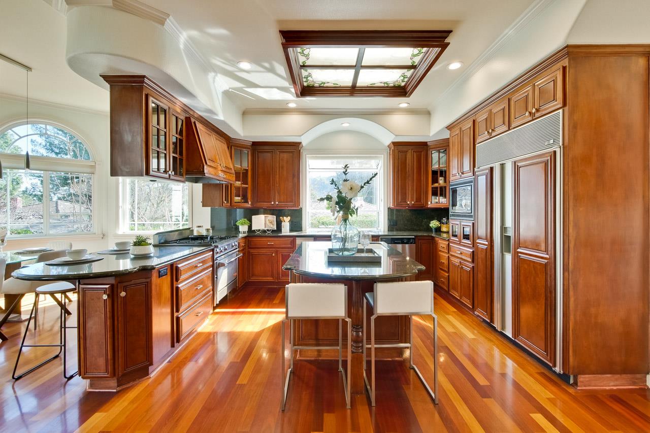 10935 Miramonte Road Cupertino, CA 95014 - Photo 20 of 71 a kitchen with stainless steel appliances granite countertop a refrigerator a sink dishwasher a stove and white countertops with wooden floor