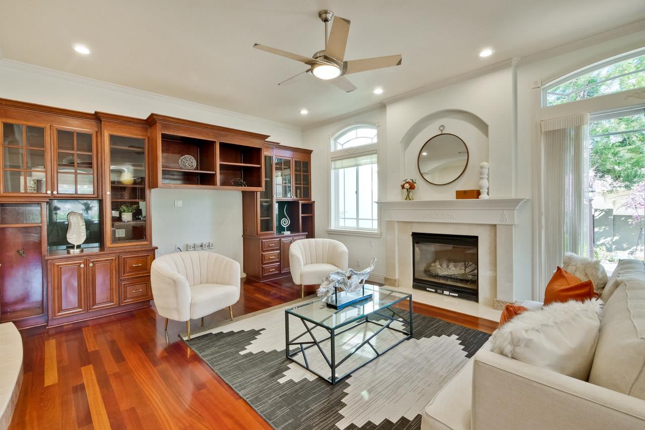 10935 Miramonte Road Cupertino, CA 95014 - Photo 31 of 71 a living room with furniture a fireplace and a floor to ceiling window