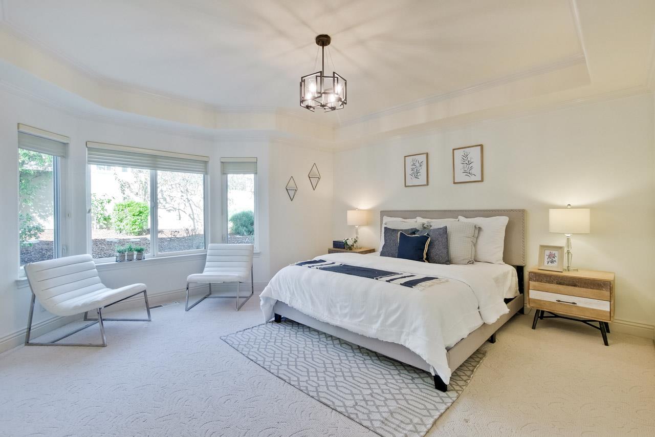 10935 Miramonte Road Cupertino, CA 95014 - Photo 38 of 71 a spacious bedroom with a bed and a chandelier