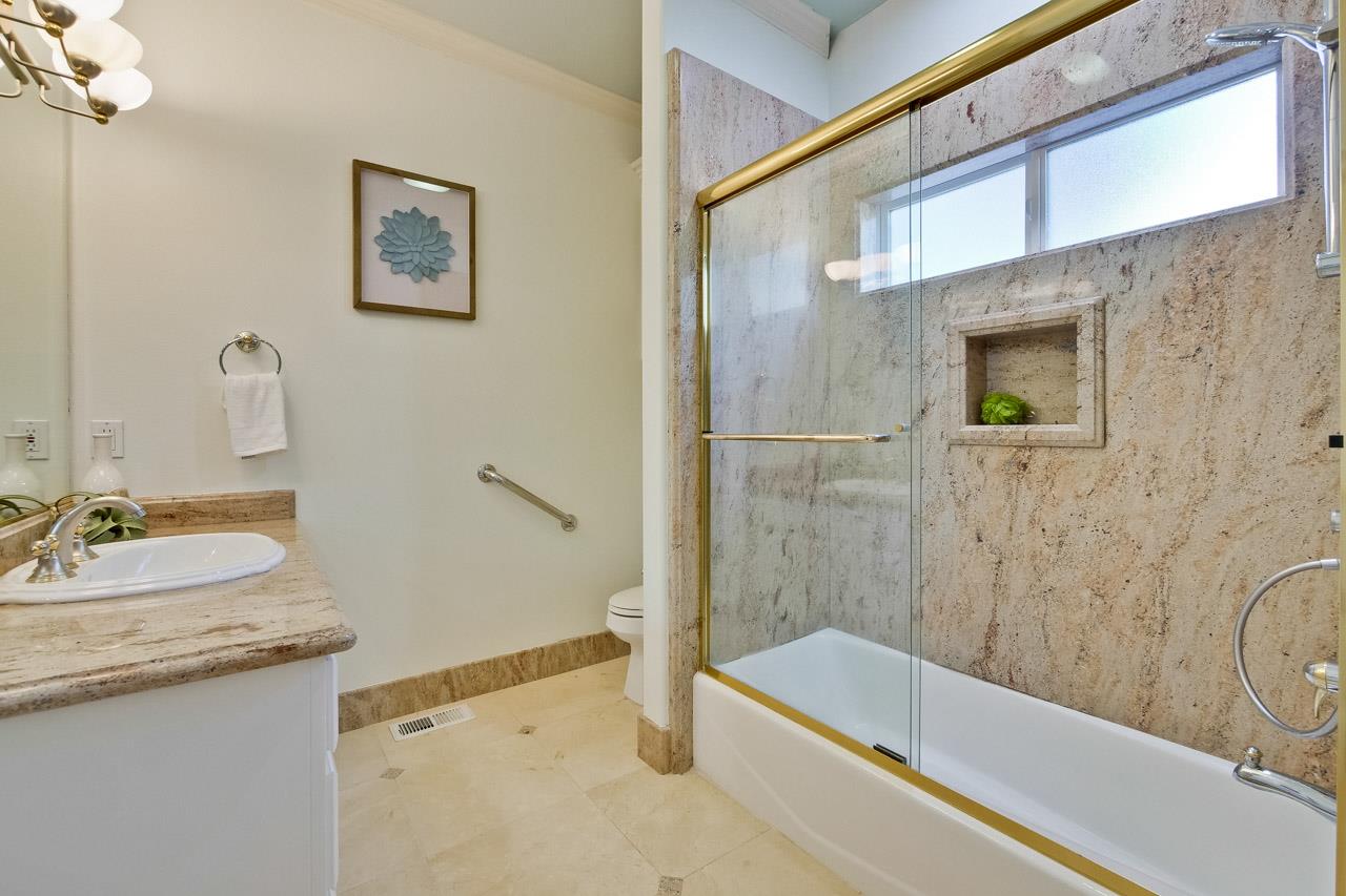 10935 Miramonte Road Cupertino, CA 95014 - Photo 40 of 71 a bathroom with a granite countertop sink a mirror a bathtub and shower