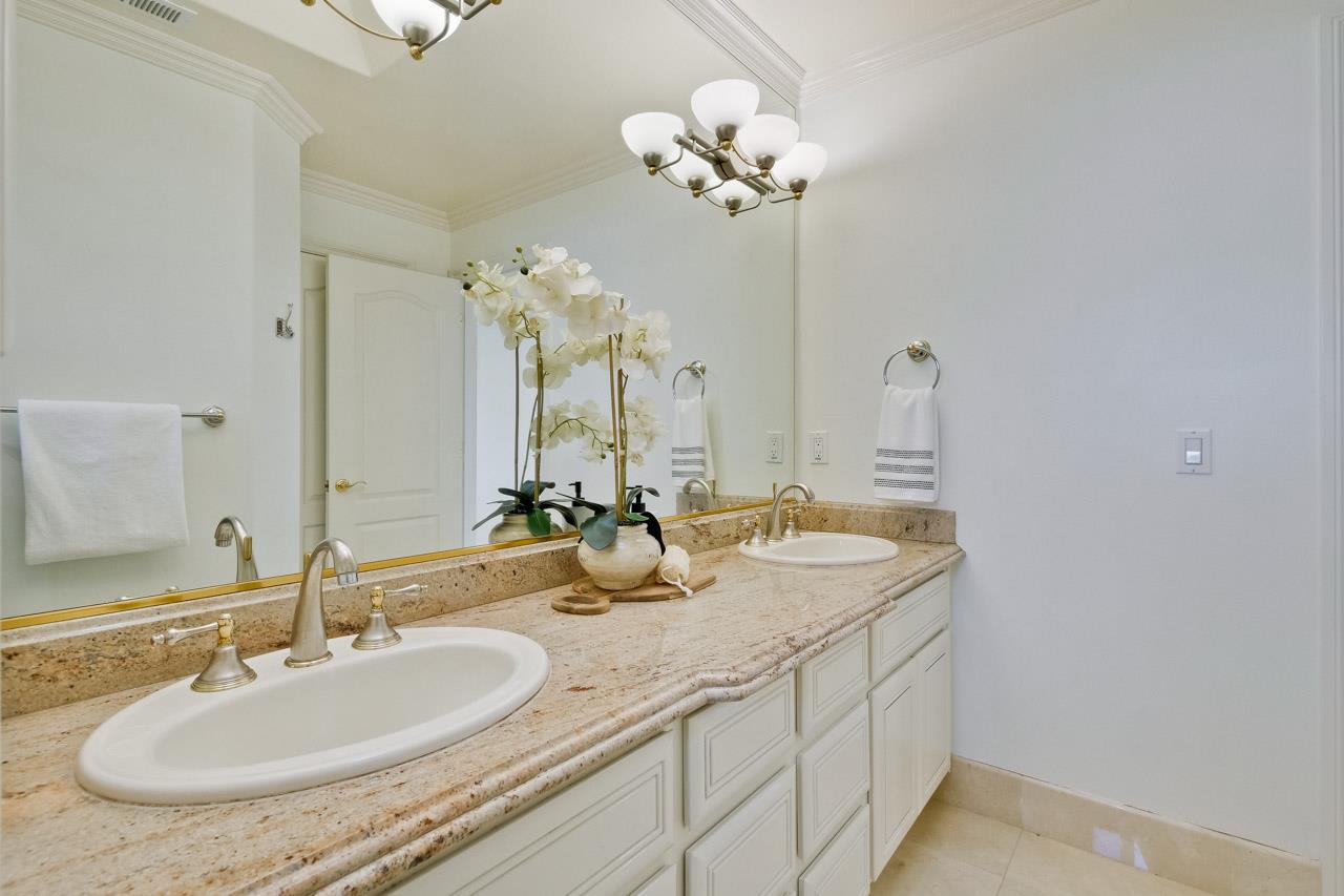10935 Miramonte Road Cupertino, CA 95014 - Photo 52 of 71 a bathroom with double vanity sinks and a mirror
