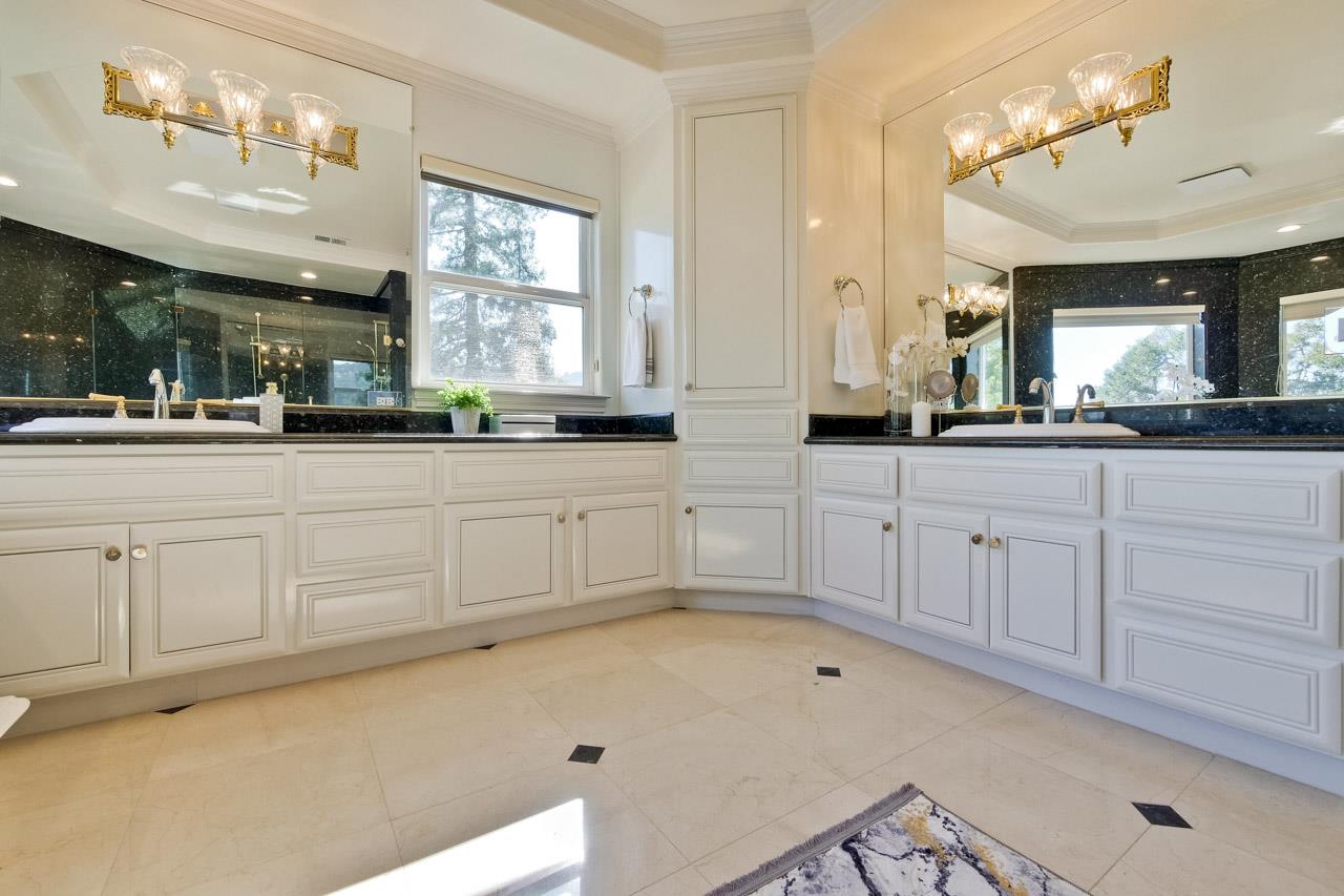 10935 Miramonte Road Cupertino, CA 95014 - Photo 60 of 71 a bathroom with a sink a large mirror and a bathtub next to a window