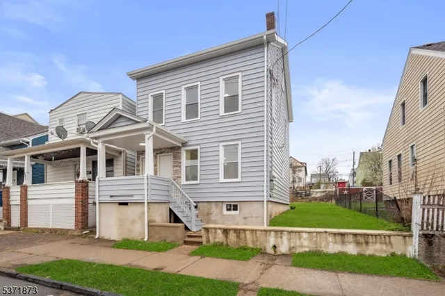 a view of a house next to a yard