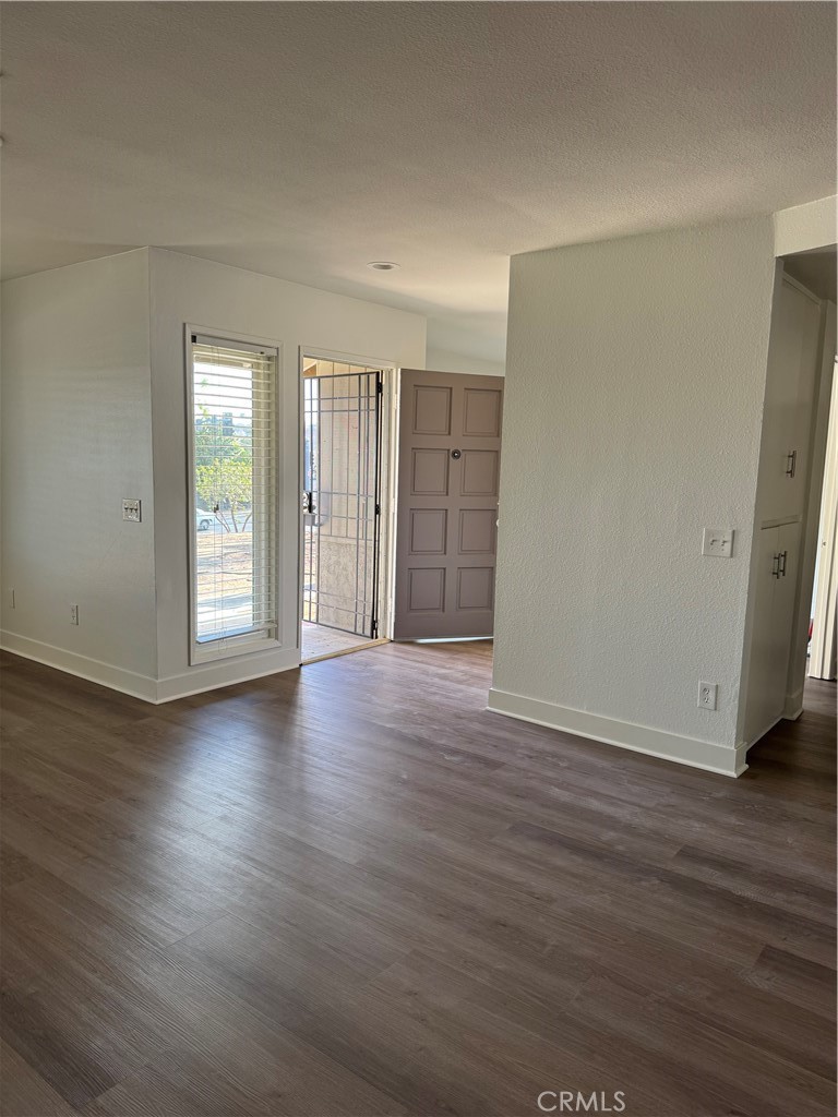 15521 Saddleback Road Riverside, CA 92506 - Photo 3 of 8 a view of an empty room with wooden floor and window