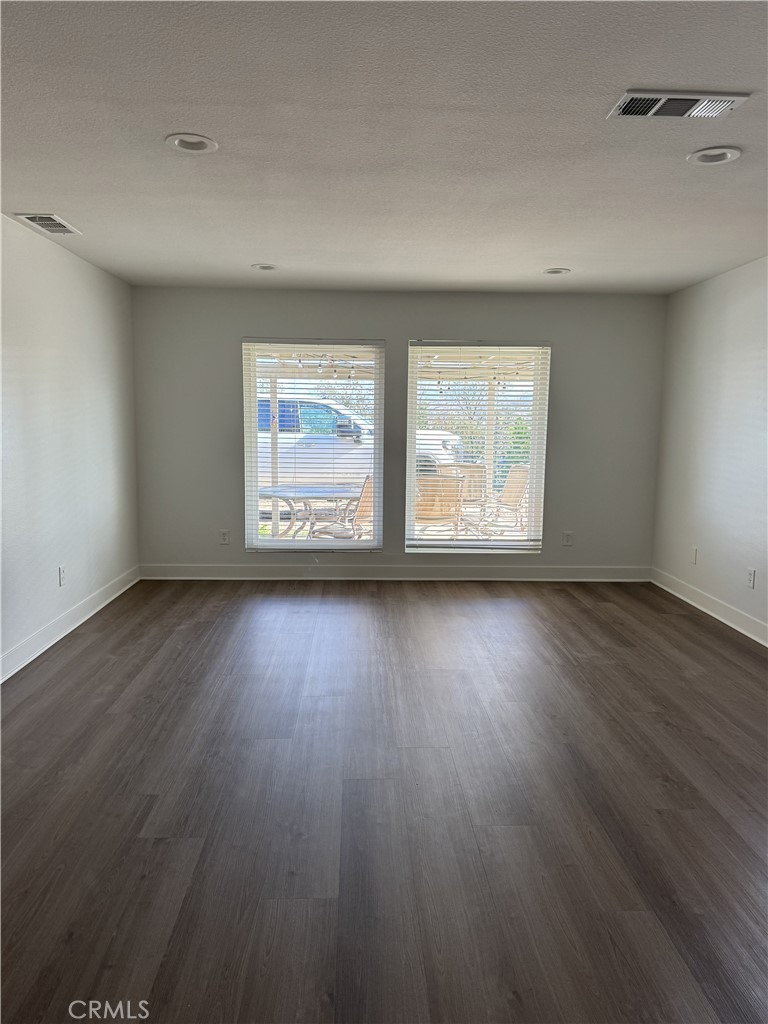 15521 Saddleback Road Riverside, CA 92506 - Photo 6 of 8 an empty room with wooden floor and windows