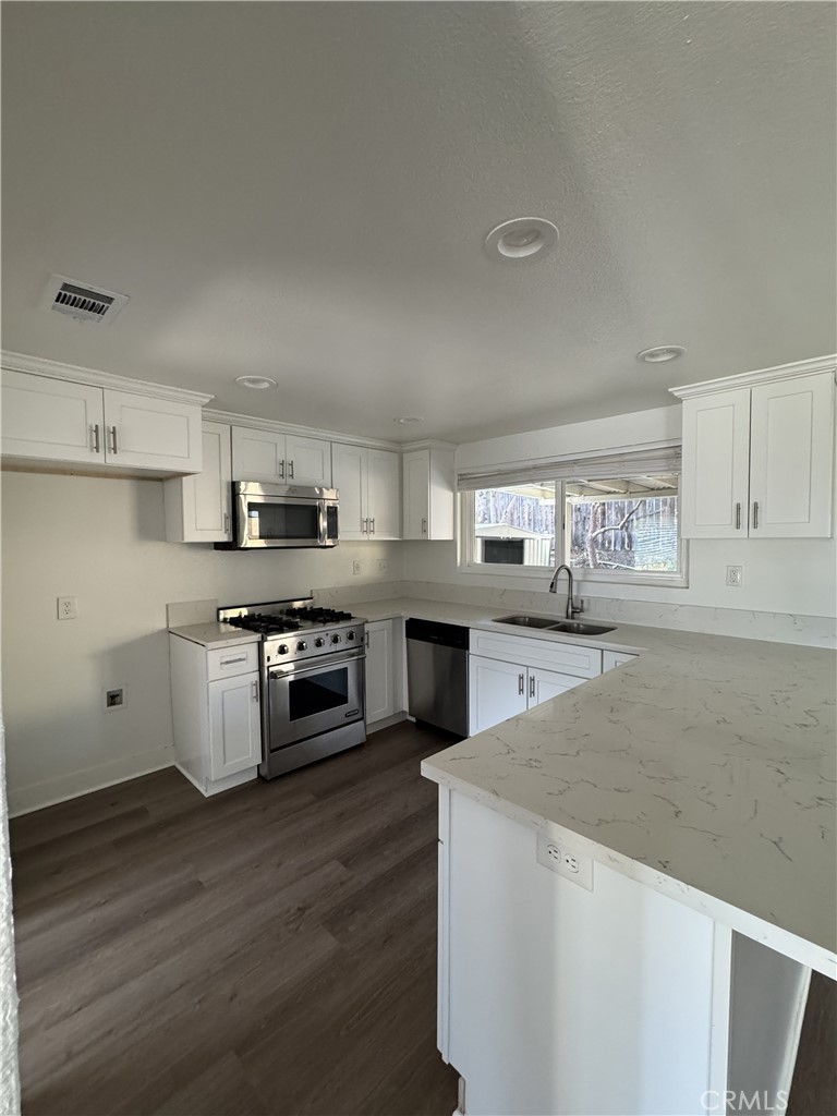 15521 Saddleback Road Riverside, CA 92506 - Photo 7 of 8 a kitchen with stainless steel appliances granite countertop a stove a sink and a refrigerator