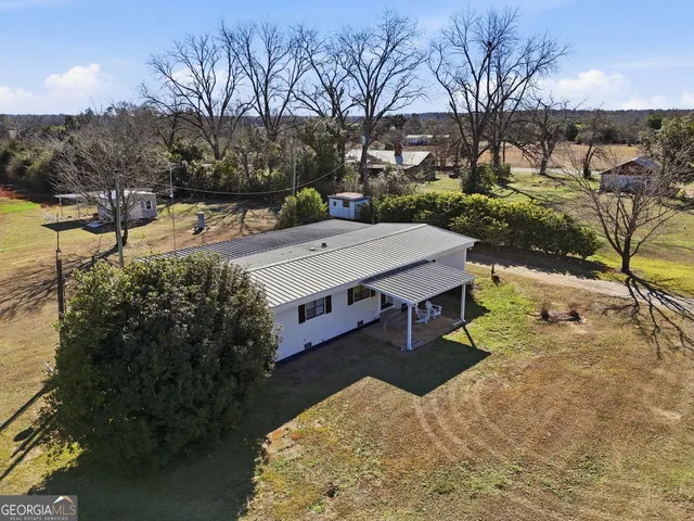 a view of a house with a yard covered in snow