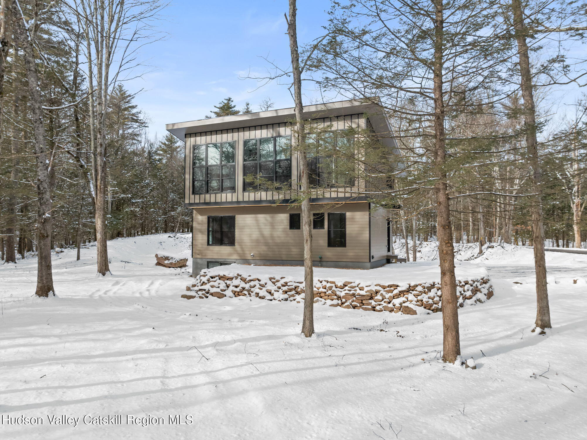 a view of a house with snow on the road
