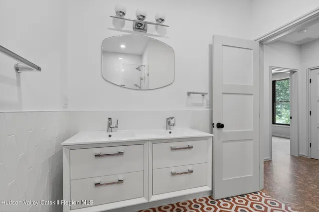 a bedroom with a large bed and a large window