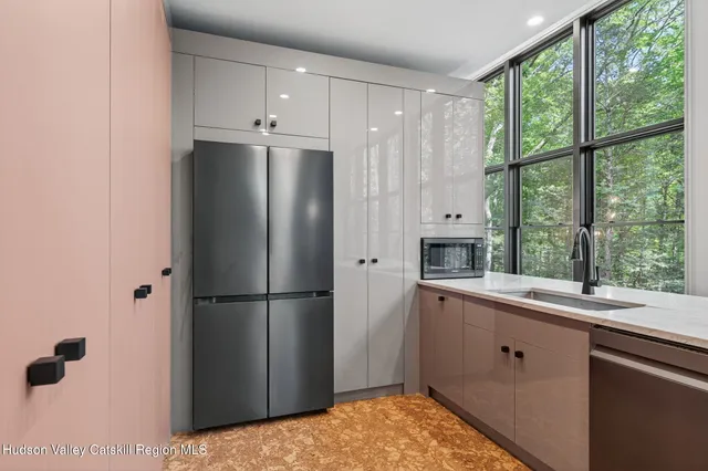 a kitchen with a sink and a large window