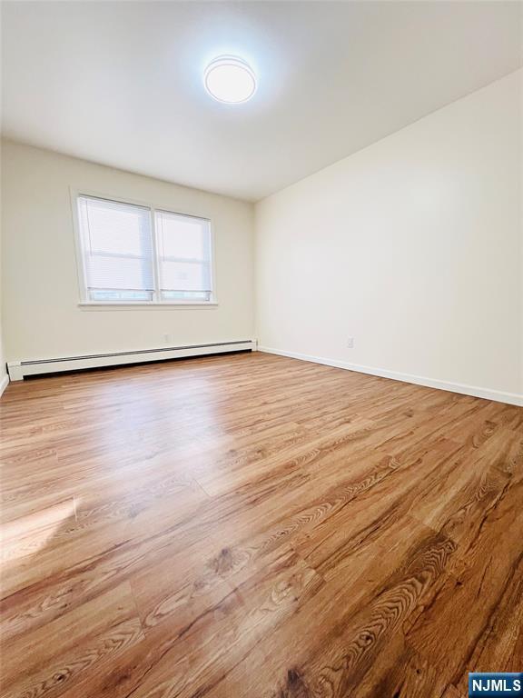 76 Front Street, Unit 2 North Arlington, NJ 07031 - Photo 11 of 13 a view of an empty room with wooden floor and a window