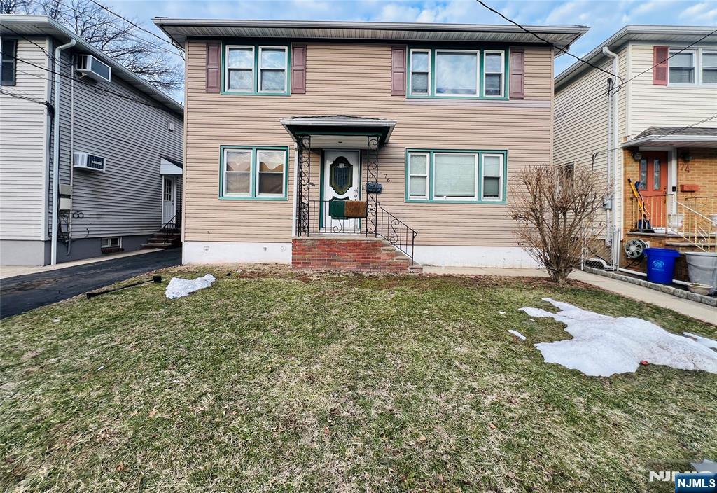 76 Front Street, Unit 2 North Arlington, NJ 07031 - Photo 13 of 13 a front view of a house with garden