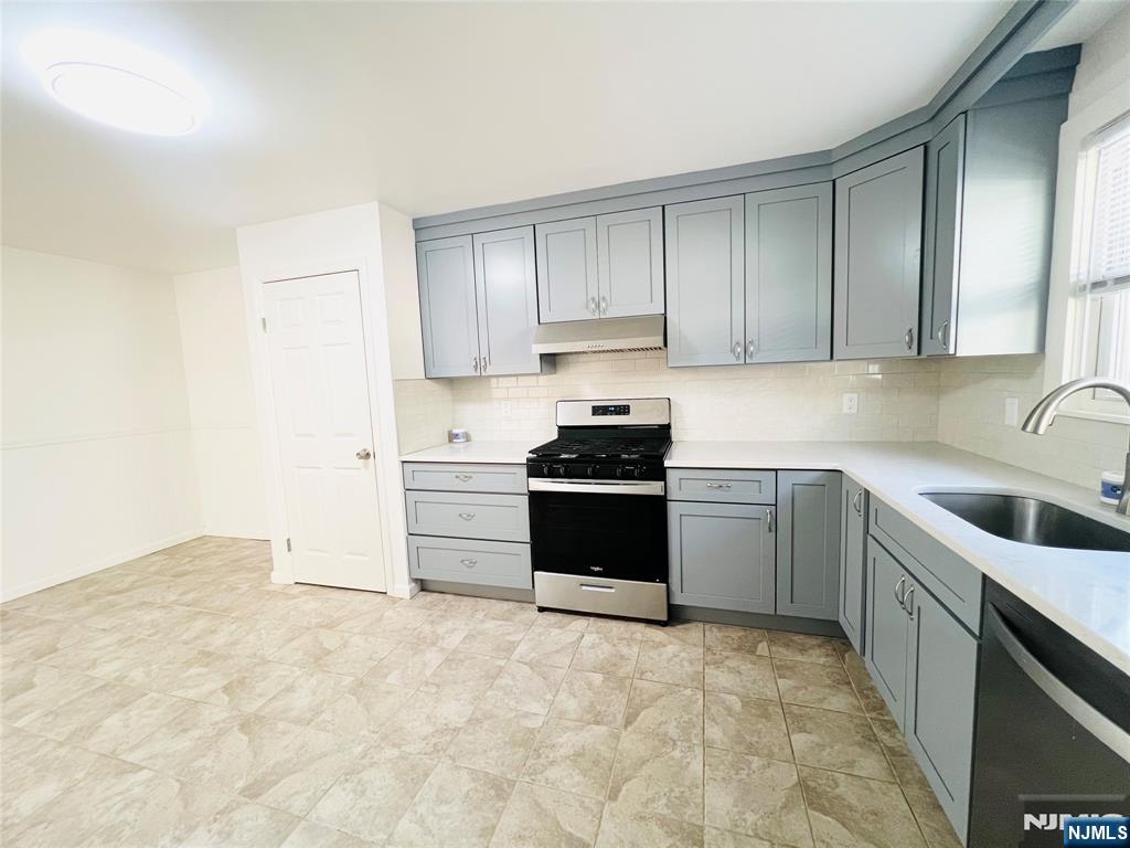 76 Front Street, Unit 2 North Arlington, NJ 07031 - Photo 4 of 13 a kitchen with a sink stove and cabinets