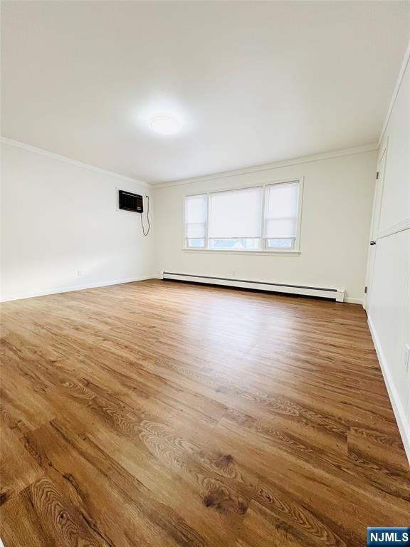 76 Front Street, Unit 2 North Arlington, NJ 07031 - Photo 6 of 13 an empty room with wooden floor and windows