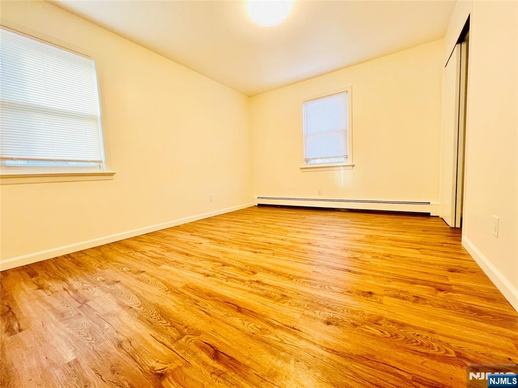 76 Front Street, Unit 2 North Arlington, NJ 07031 - Photo 10 of 13 a view of empty room with wooden floor and fan