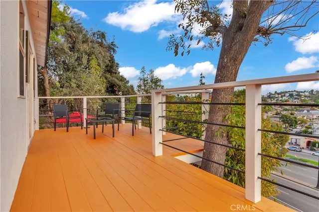 a view of a patio with a table and chairs under an umbrella