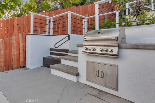 a view of patio with a table and chairs under an umbrella