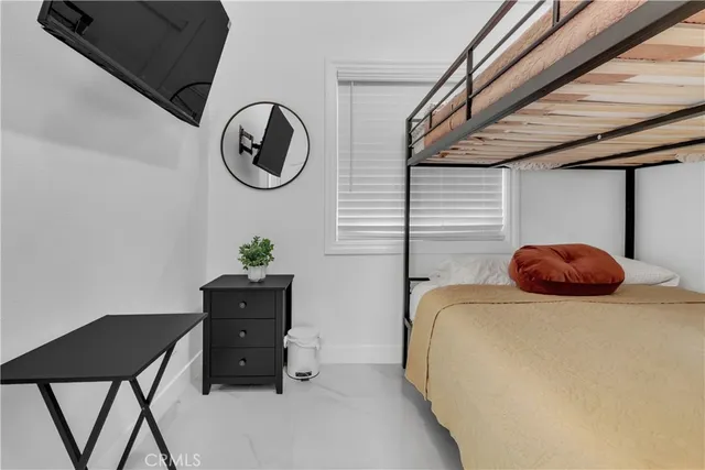 a bedroom with a bed and window