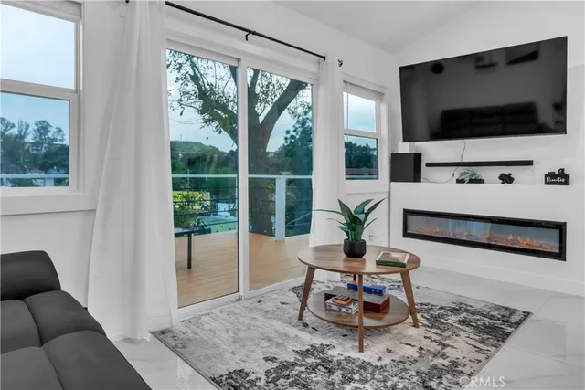 a bedroom with a bed and flat tv screen on the table
