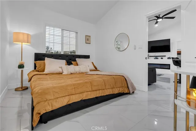 a bedroom with a bed and a flat screen tv