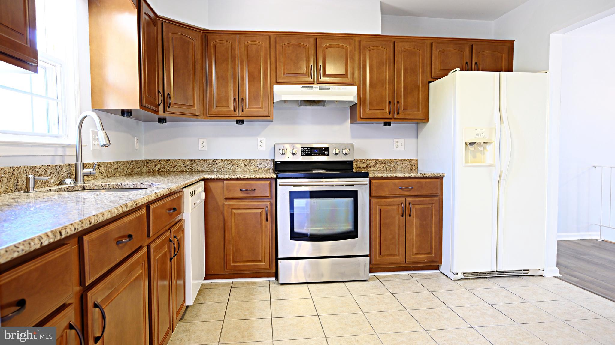 1950 Aberdeen Drive Dunkirk, MD 20754 - Photo 8 of 21 a kitchen with granite countertop a stove a sink and a refrigerator