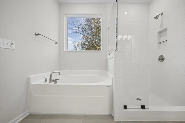a white bath tub sitting next to a white sink