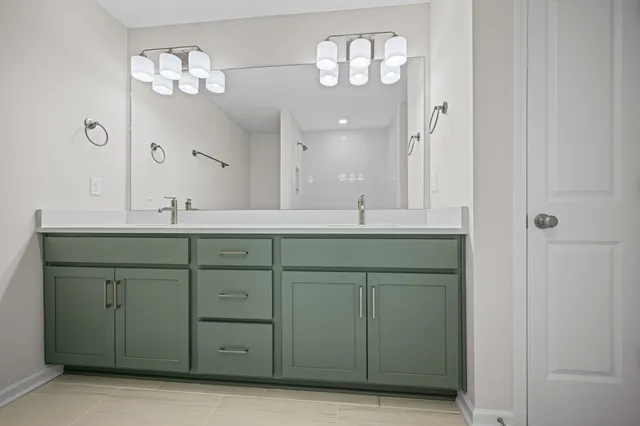 a bathroom with a double vanity sink and a mirror