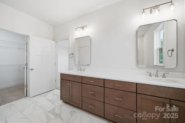 a spacious bathroom with a double vanity sink double and mirror