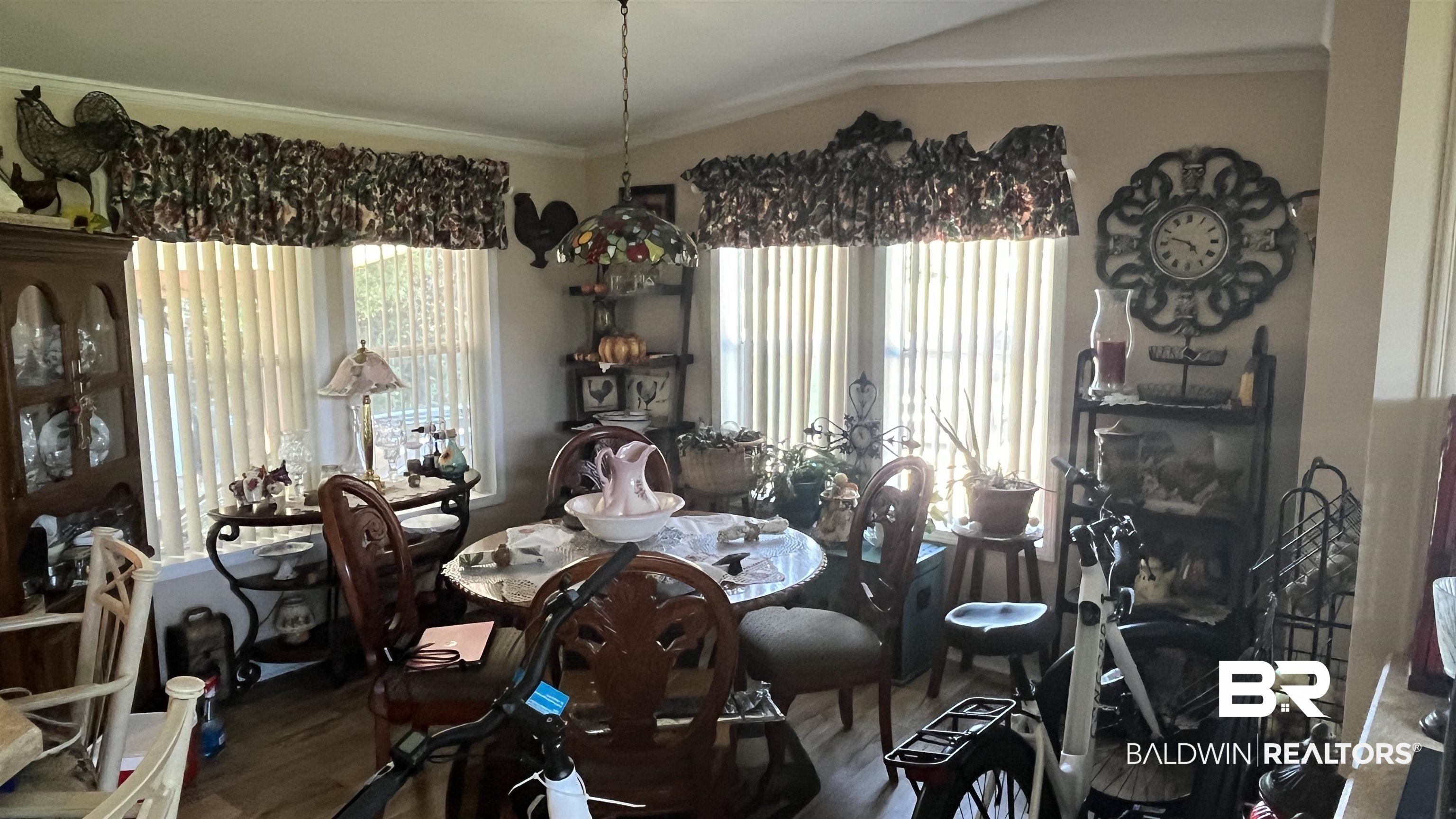12932 Santa Piedro Street Lillian, AL 36549 - Photo 6 of 20 Dining area with healthy amount of natural light, wood finished floors, lofted ceiling, and ornamental molding