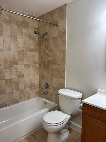 a white toilet and shower sitting next to a bathroom sink