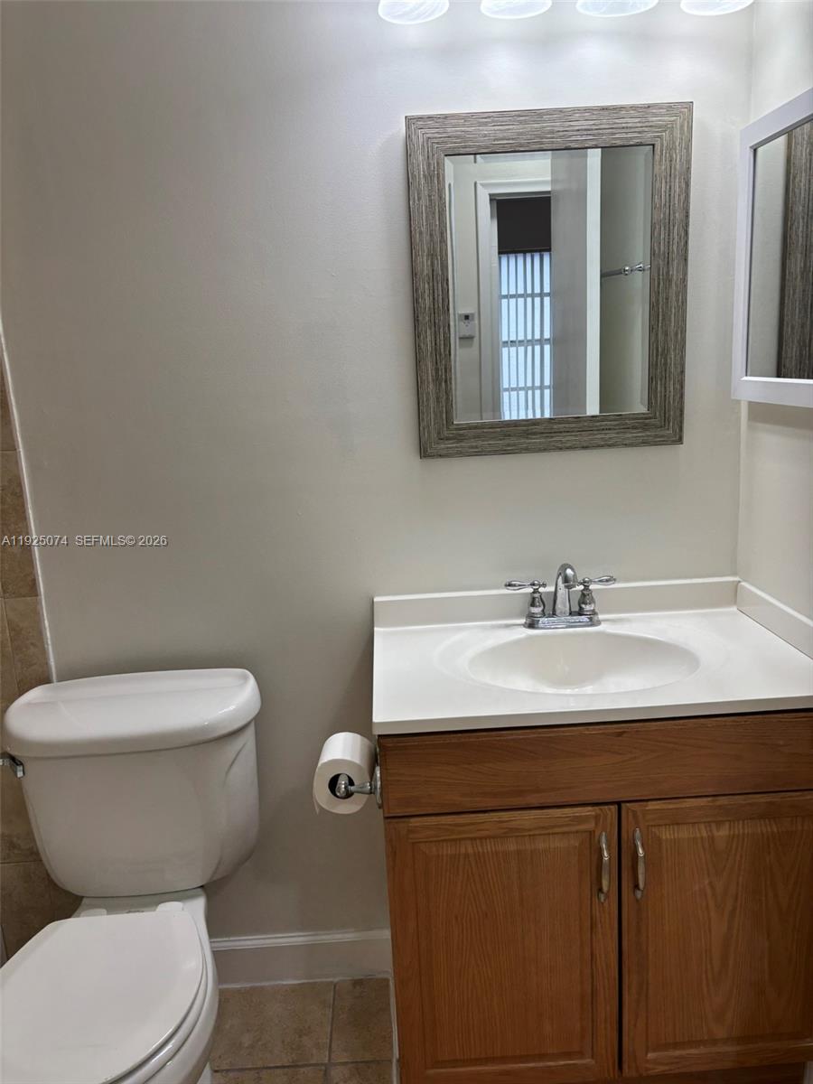 7331 Southwest 149th Court Miami, FL 33193 - Photo 14 of 25 a bathroom with a toilet sink and mirror
