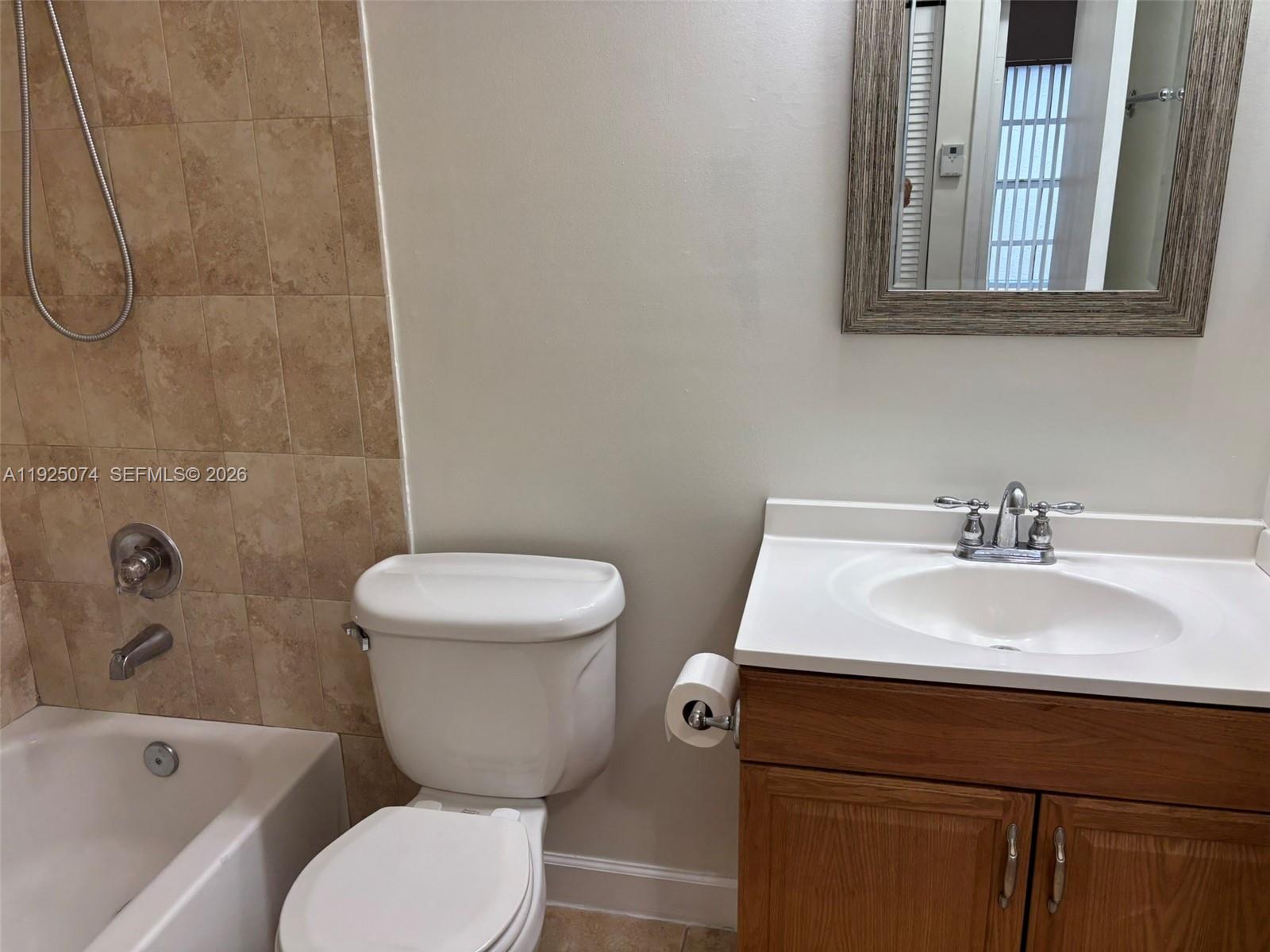 7331 Southwest 149th Court Miami, FL 33193 - Photo 15 of 25 a bathroom with a toilet sink and mirror
