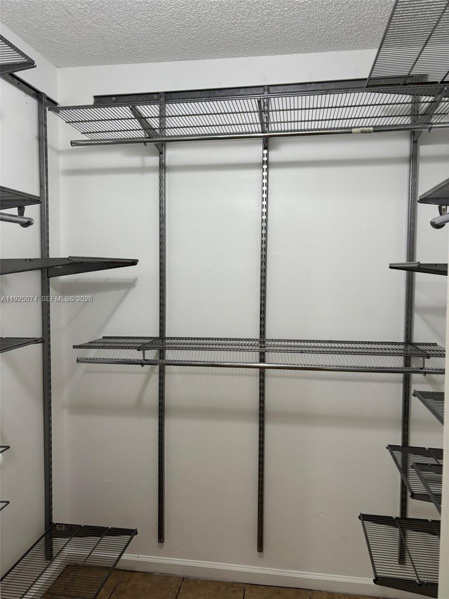 7331 Southwest 149th Court Miami, FL 33193 - Photo 18 of 25 a view of a room with racks on the wall