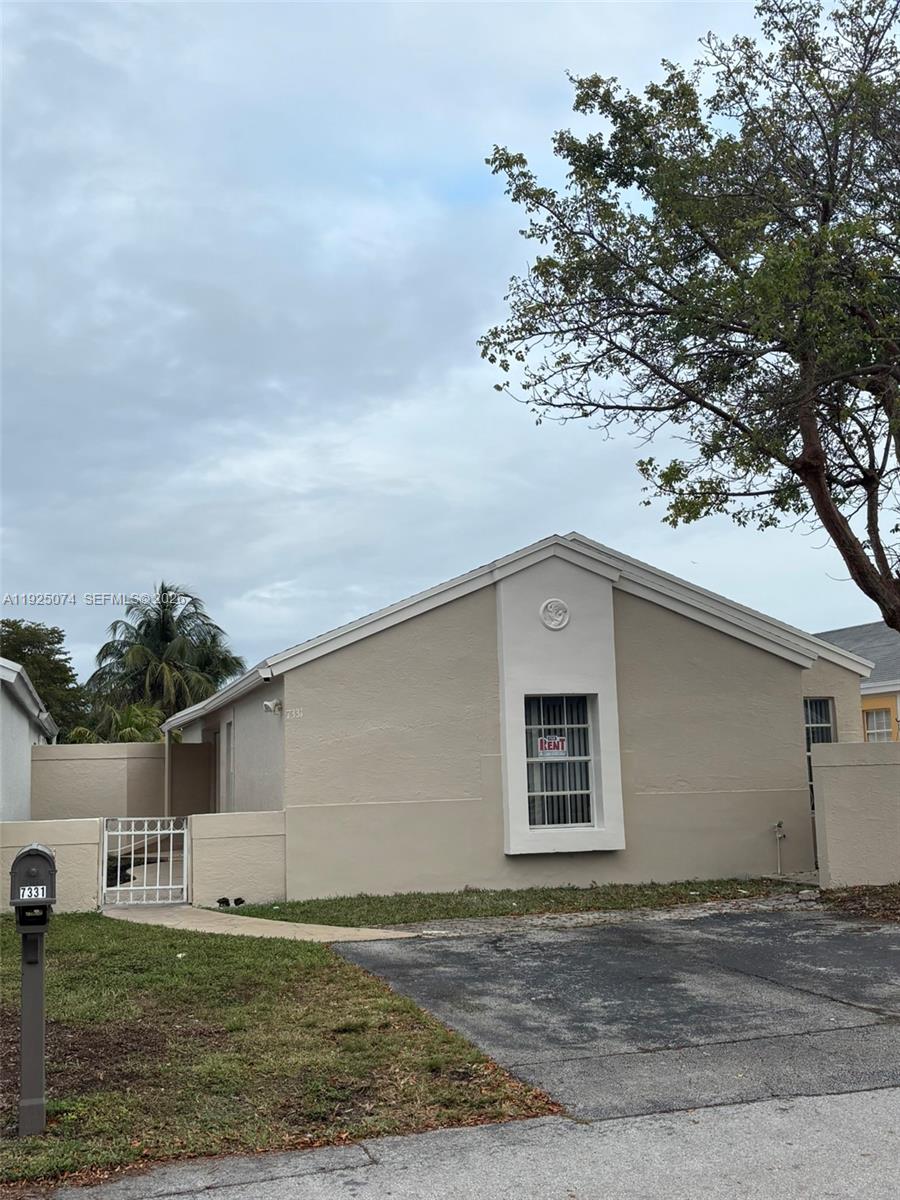 7331 Southwest 149th Court Miami, FL 33193 - Photo 25 of 25 a front view of a house with a yard