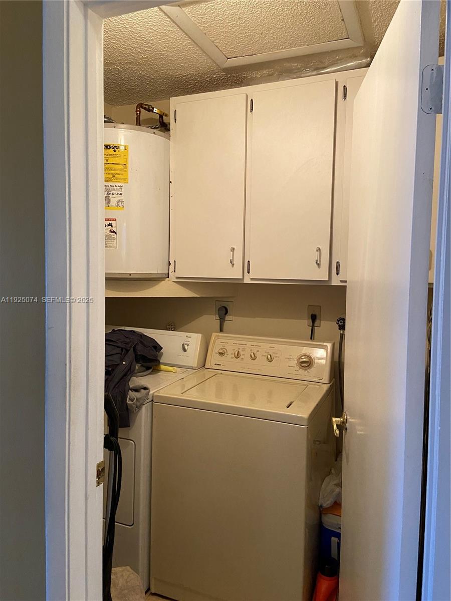 7331 Southwest 149th Court Miami, FL 33193 - Photo 3 of 10 a utility room with dryer and washer