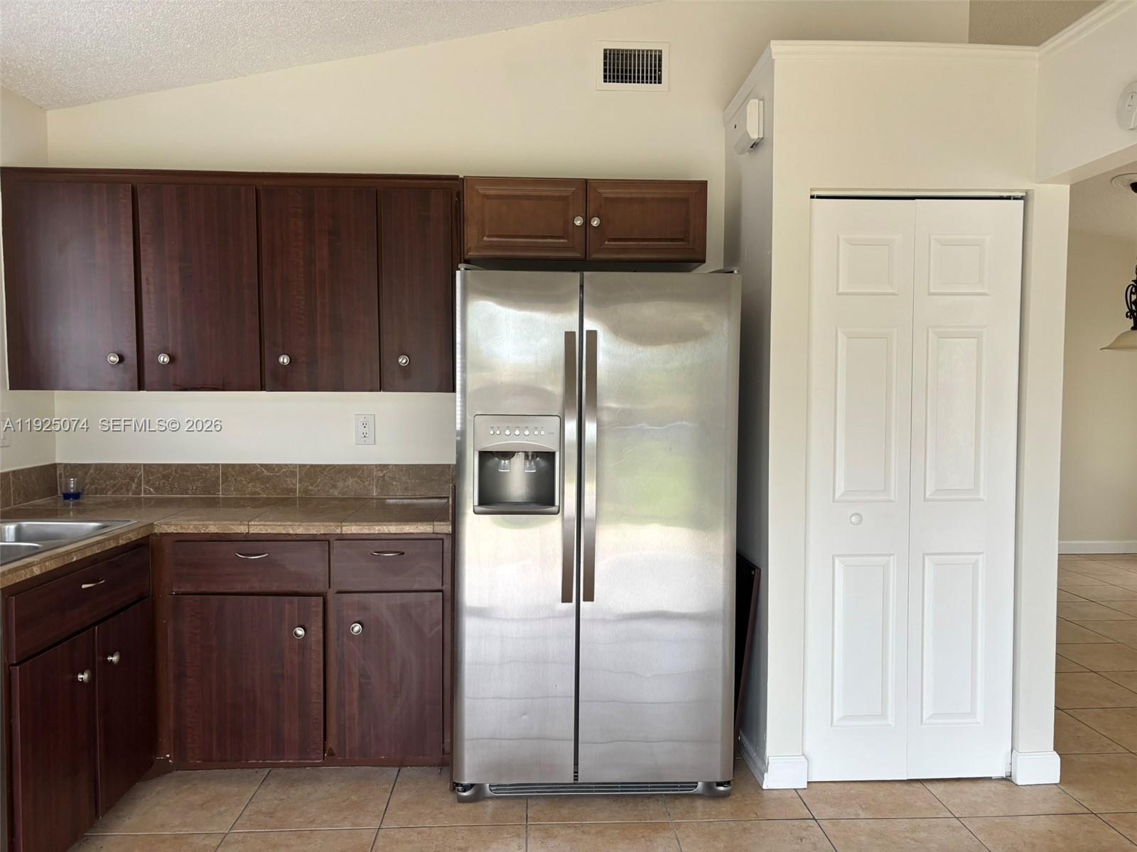 7331 Southwest 149th Court Miami, FL 33193 - Photo 5 of 25 a kitchen with a refrigerator and cabinets