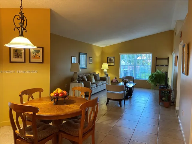 a living room with furniture a window and a dining table