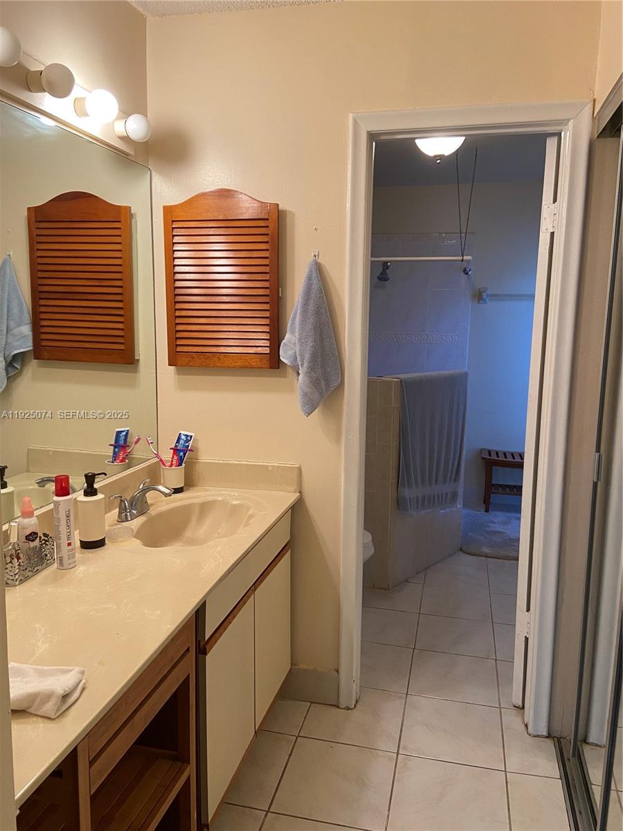 7331 Southwest 149th Court Miami, FL 33193 - Photo 8 of 10 a bathroom with a sink and a mirror