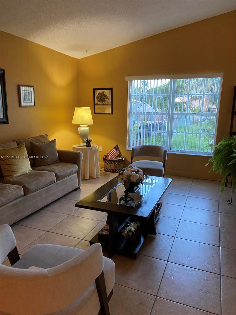 7331 Southwest 149th Court Miami, FL 33193 - Photo 9 of 10 a living room with furniture and a window