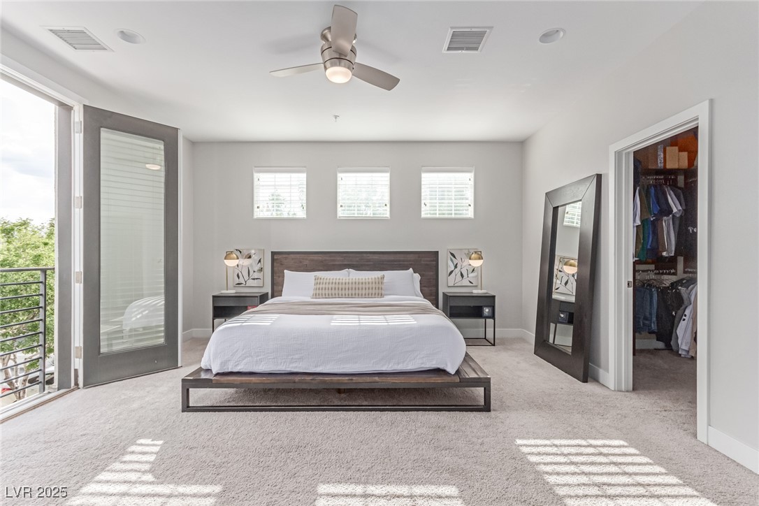 3165 Via Como Henderson, NV 89044 - Photo 11 of 42 Bedroom with a spacious closet, carpet flooring, access to exterior, and baseboards