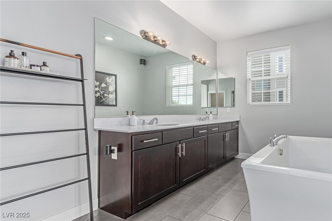 3165 Via Como Henderson, NV 89044 - Photo 12 of 42 Full bath with tile patterned floors, a freestanding bath, and double vanity