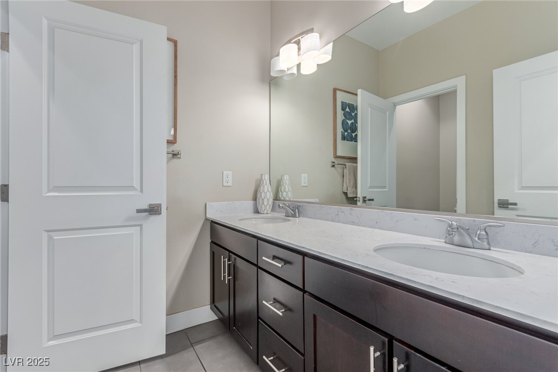 3165 Via Como Henderson, NV 89044 - Photo 15 of 42 Bathroom featuring tile patterned floors, double vanity, and baseboards