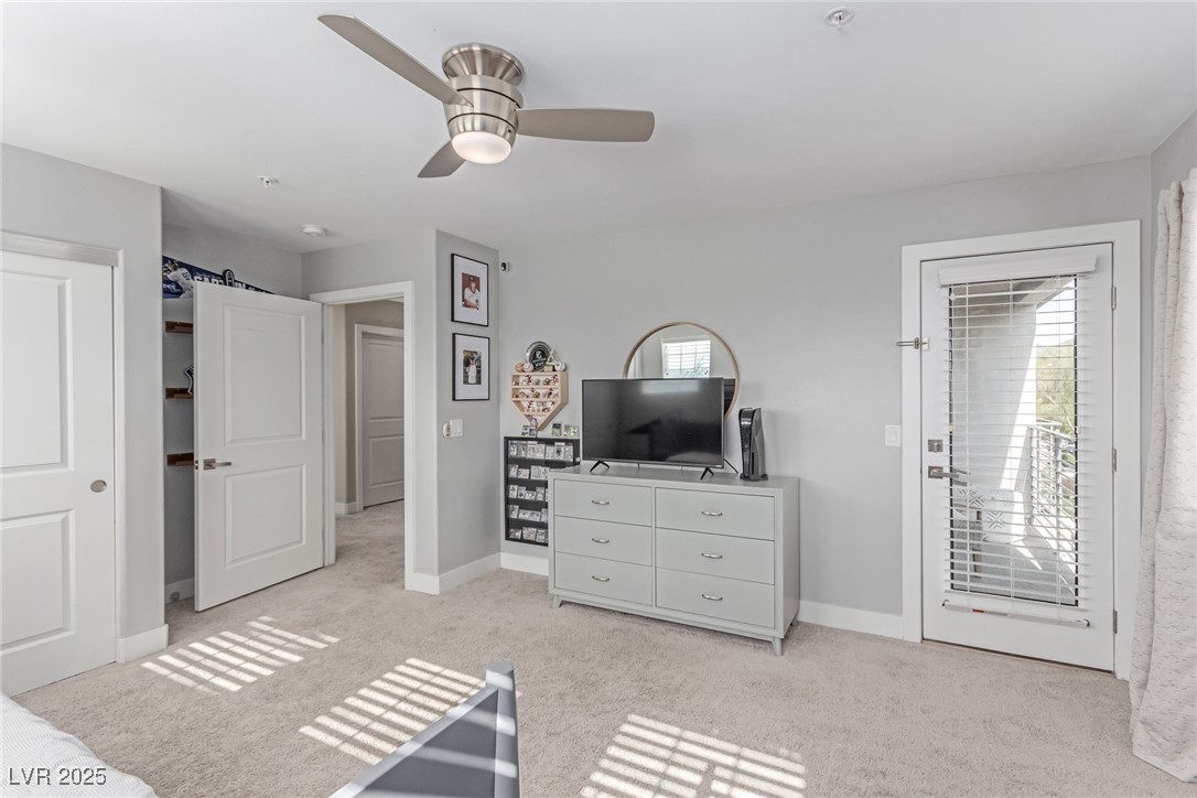 3165 Via Como Henderson, NV 89044 - Photo 25 of 42 Bedroom with access to outside, light carpet, baseboards, and a ceiling fan