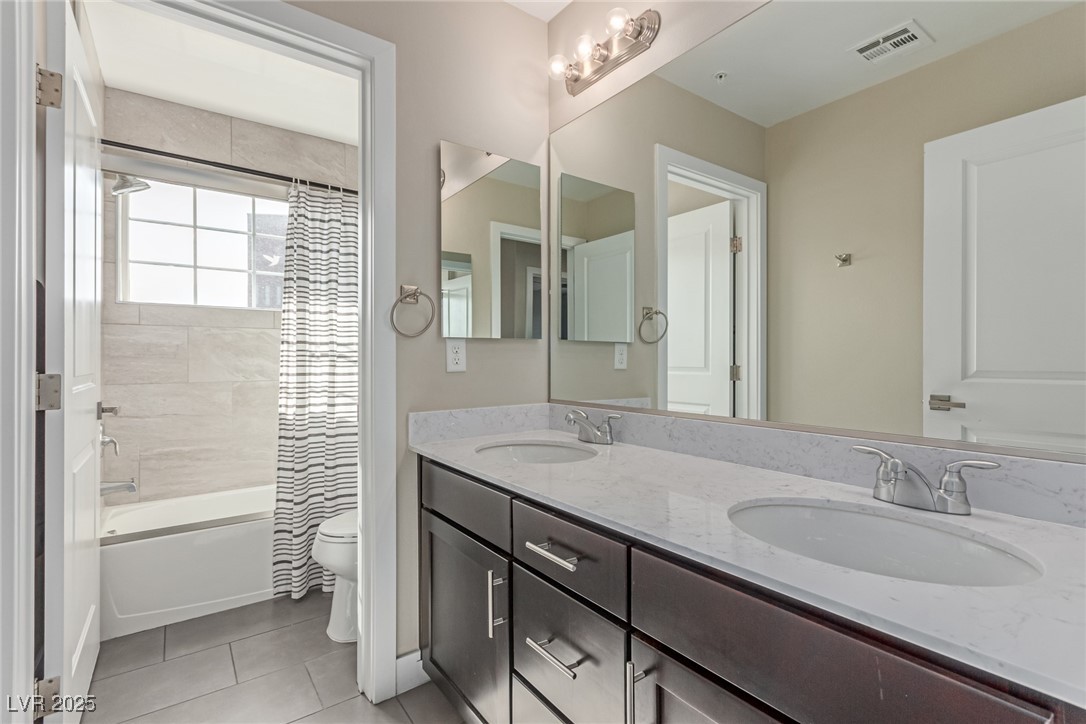 3165 Via Como Henderson, NV 89044 - Photo 26 of 42 Full bathroom featuring toilet, tile patterned floors, double vanity, and shower / tub combo