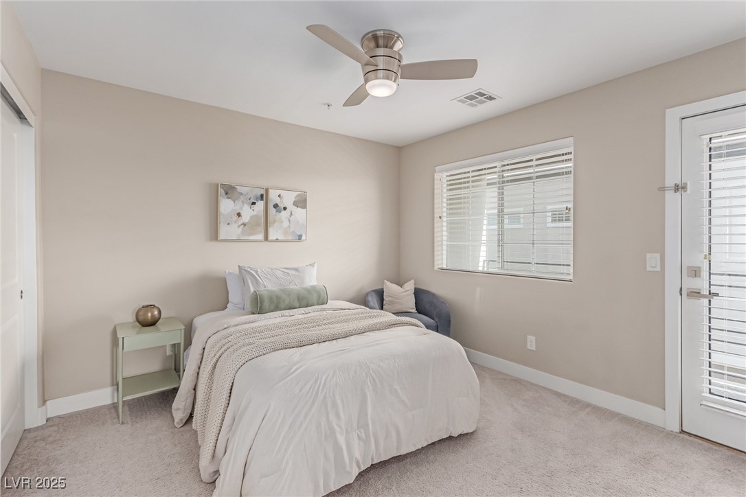 3165 Via Como Henderson, NV 89044 - Photo 27 of 42 Bedroom with light carpet, baseboards, a ceiling fan, and a closet