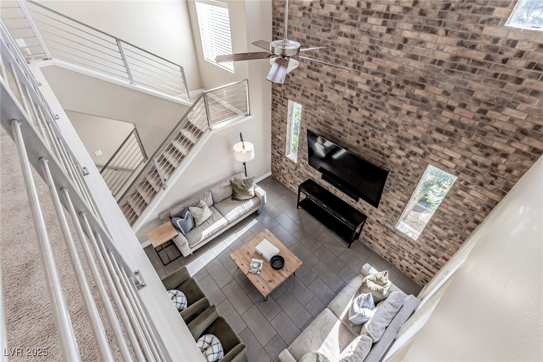 3165 Via Como Henderson, NV 89044 - Photo 4 of 42 Living room with a towering ceiling, ceiling fan, and tile patterned floors