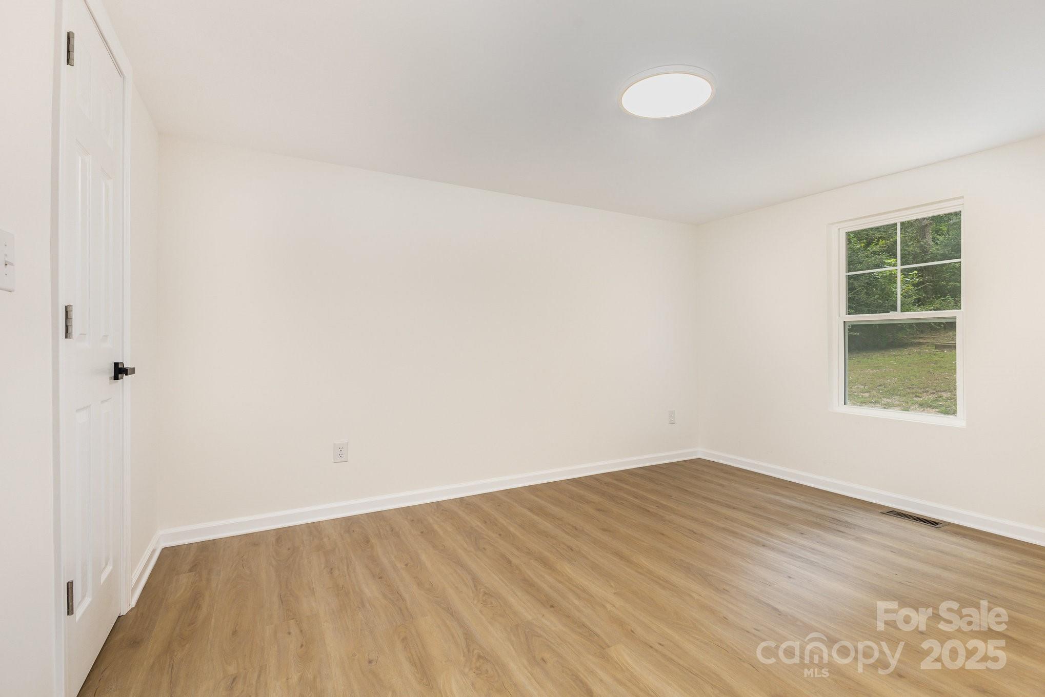 12180 A Coyle Road Stanfield, NC 28163 - Photo 12 of 16 an empty room with a window